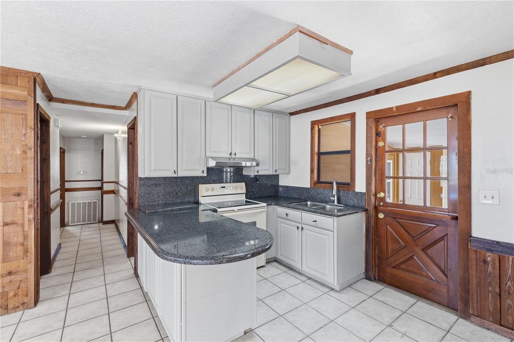 10301 Trail Ridge Lane Tampa, FL 33624 - Photo 8 of 35 a kitchen with stainless steel appliances granite countertop a sink stove and cabinets