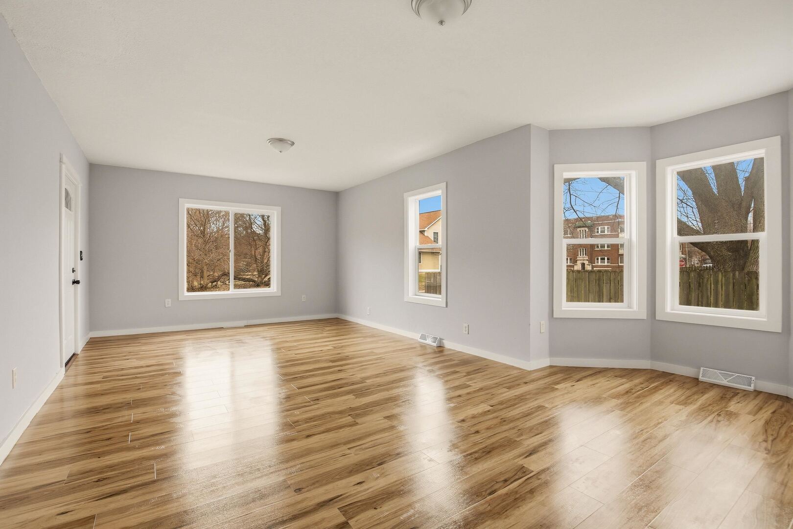 1928 8th Avenue Rock Island, IL 61201 - Photo 12 of 33 a view of an empty room with wooden floor and a window