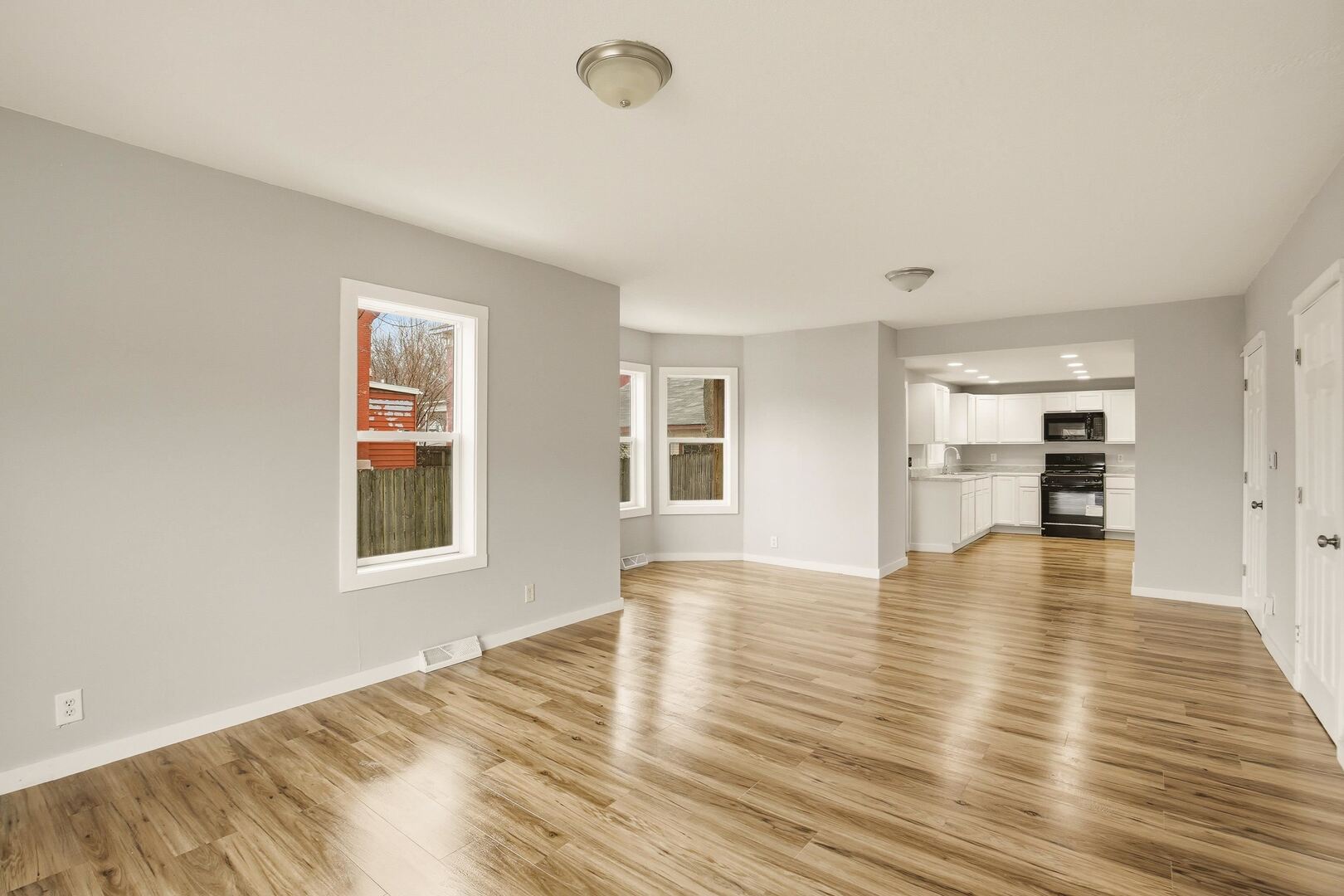 1928 8th Avenue Rock Island, IL 61201 - Photo 10 of 33 an empty room with wooden floor and windows