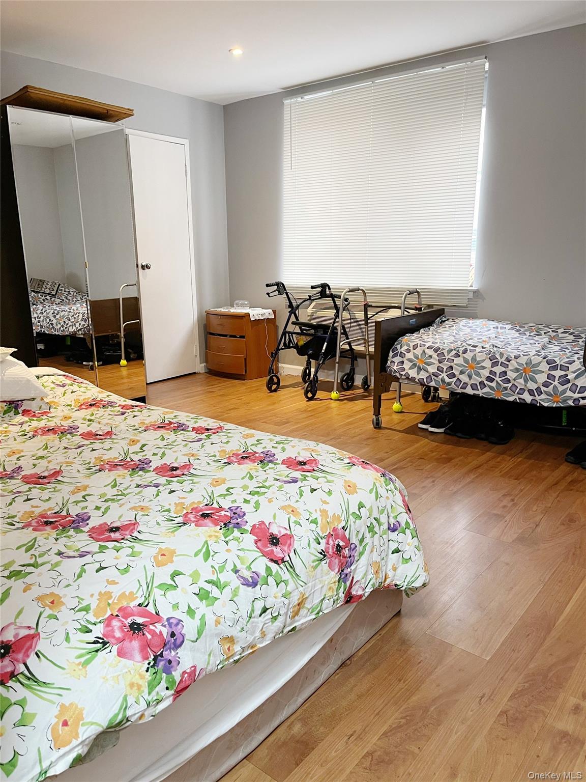 10 Canterbury Road, Unit 1B Great Neck, NY 11021 - Photo 4 of 10 a bedroom with bed and window