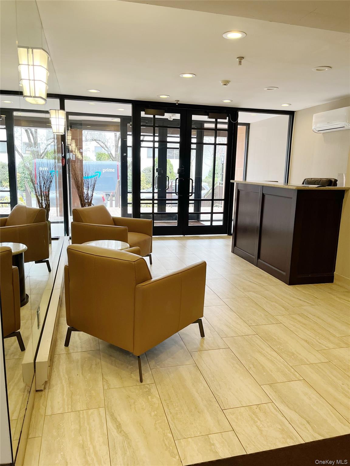10 Canterbury Road, Unit 1B Great Neck, NY 11021 - Photo 5 of 10 a living room with furniture and large windows