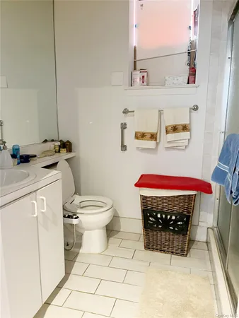a bathroom with a toilet a sink and a shower