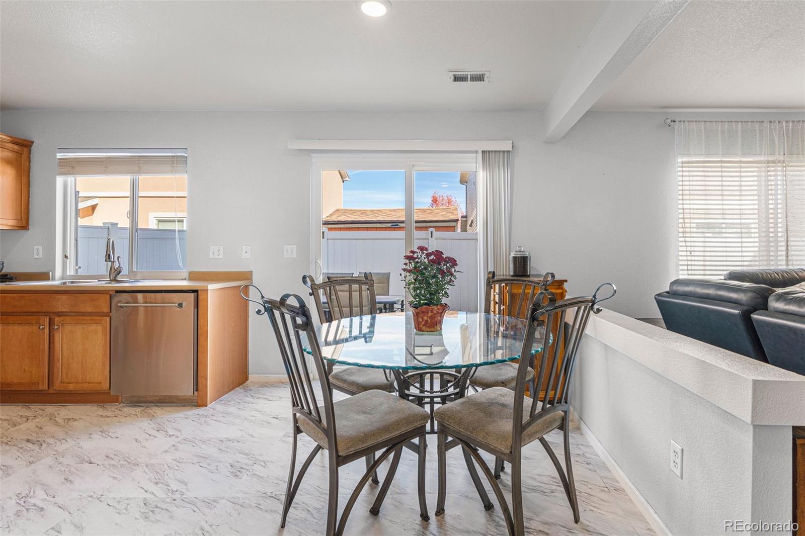 19525 Robins Drive Denver, CO 80249 - Photo 11 of 44 a view of a dining room with furniture and window
