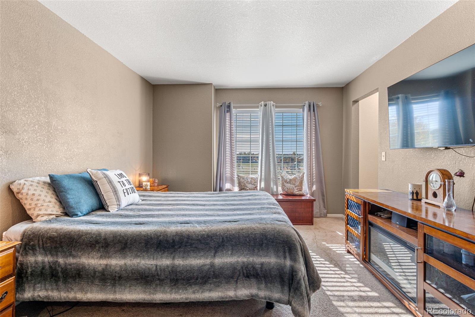 19525 Robins Drive Denver, CO 80249 - Photo 26 of 44 a bedroom with a bed and wooden floor