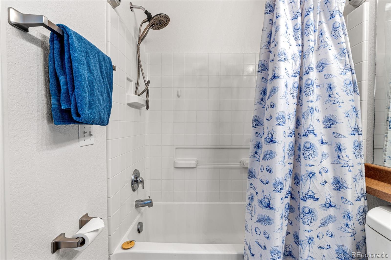 19525 Robins Drive Denver, CO 80249 - Photo 30 of 44 a bathroom with a shower and a shower curtain
