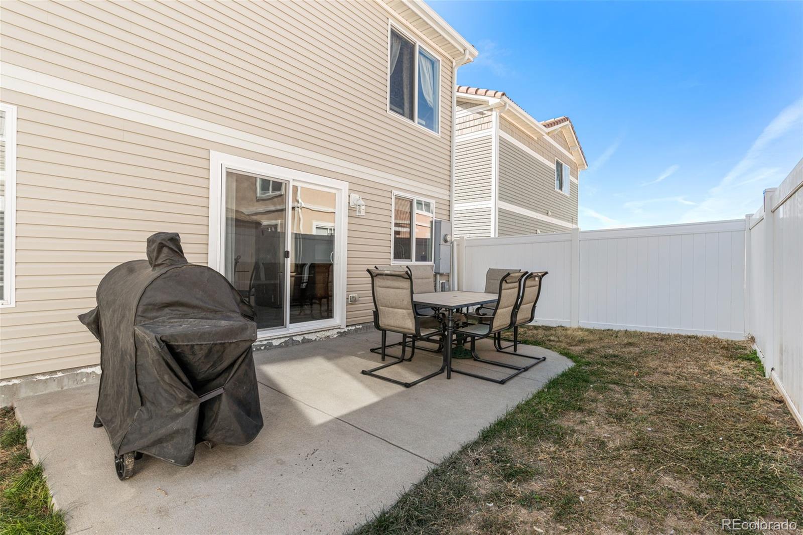 19525 Robins Drive Denver, CO 80249 - Photo 38 of 44 a view of a patio with table and chairs and potted plants