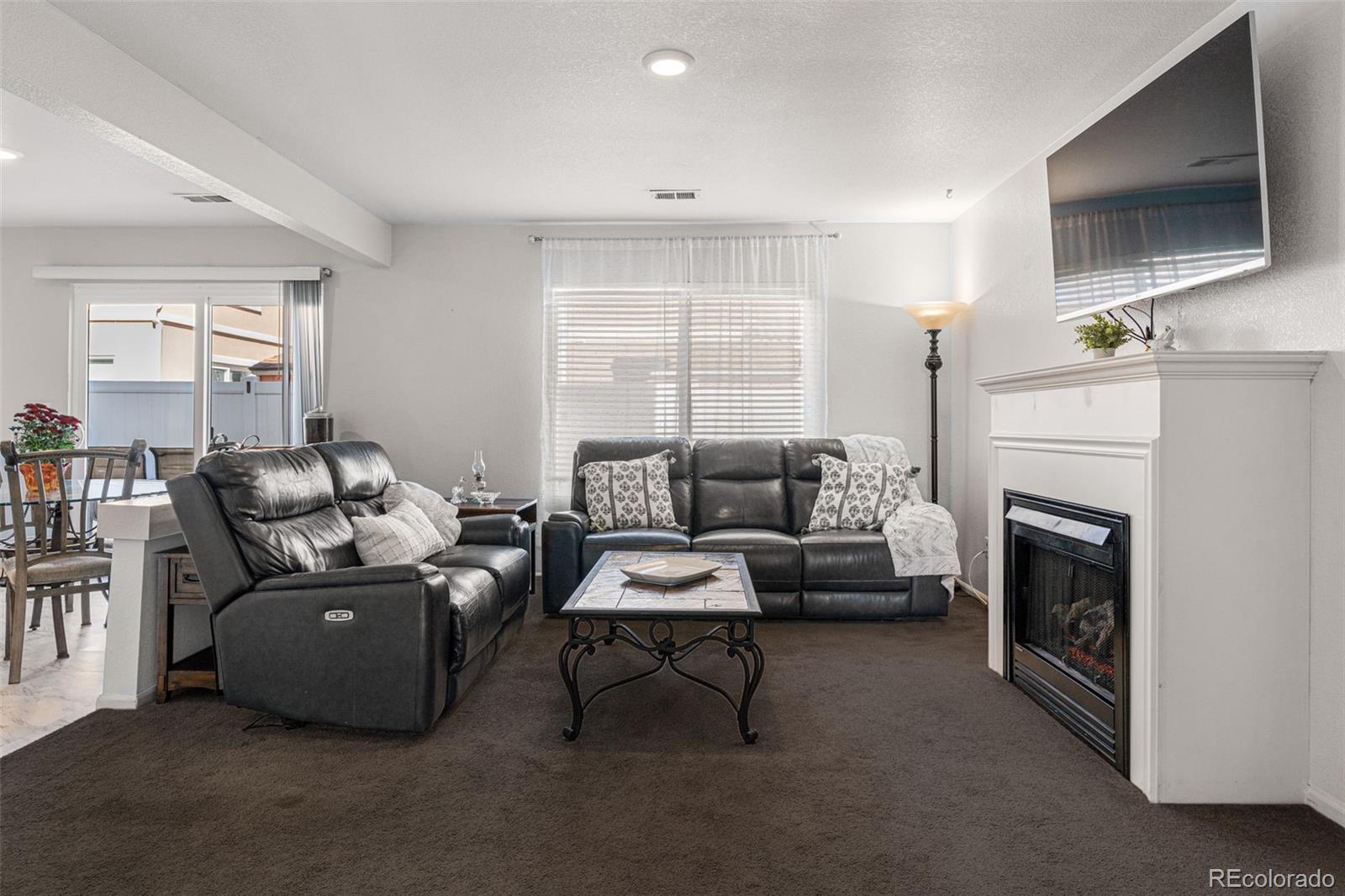 19525 Robins Drive Denver, CO 80249 - Photo 5 of 44 a living room with furniture and a fireplace