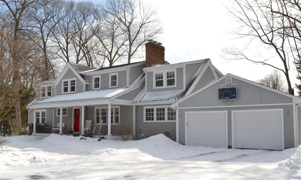 21 Dane Road Lexington, MA 02421 - Photo 1 of 25 a front view of a house with a yard covered in snow