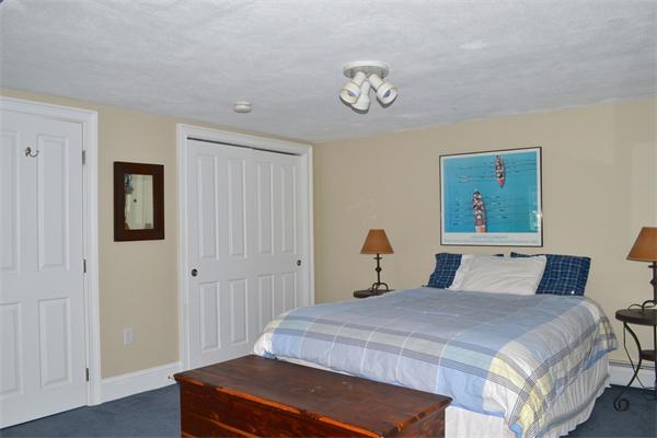 21 Dane Road Lexington, MA 02421 - Photo 22 of 25 a bedroom with a bed and a chandelier