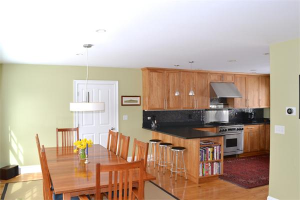 21 Dane Road Lexington, MA 02421 - Photo 4 of 25 a kitchen with granite countertop a stove a sink a dining table and chairs