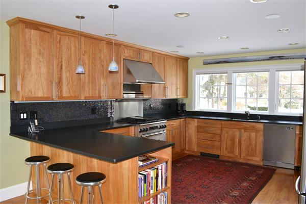 21 Dane Road Lexington, MA 02421 - Photo 5 of 25 a kitchen with a stove a sink and a refrigerator