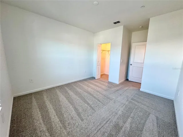 a view of an empty room and a window