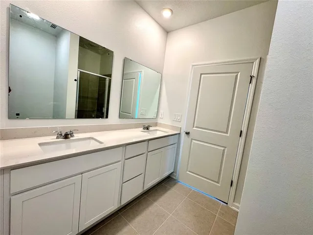 a bathroom with 2 sink and a mirror
