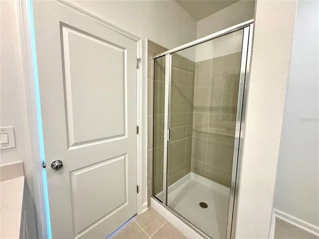 a bathroom with a glass shower door