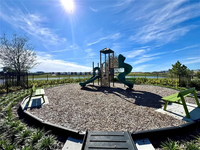 a view of a roof deck with couches and wooden floor