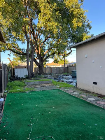a view of a backyard with large trees