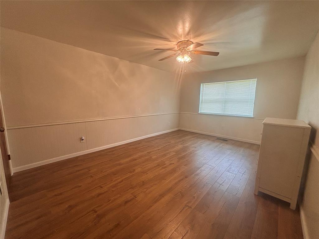 5355 Banks Road Fort Worth, TX 76140 - Photo 7 of 29 a view of a livingroom with wooden floor and a ceiling fan