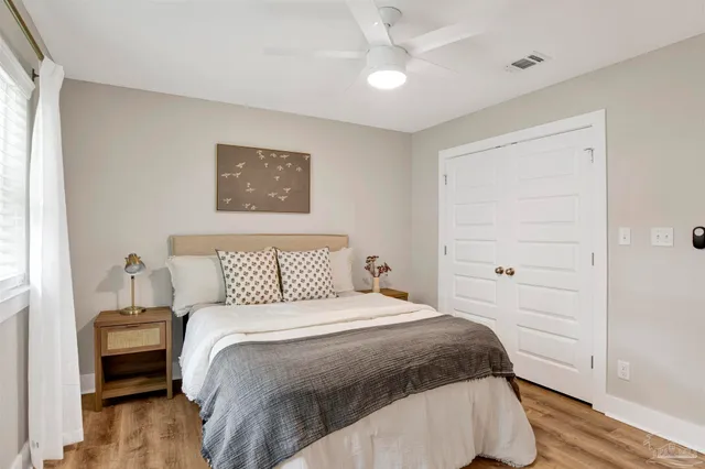 a bedroom with a bed and a night stand