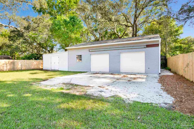 a view of a house with a backyard