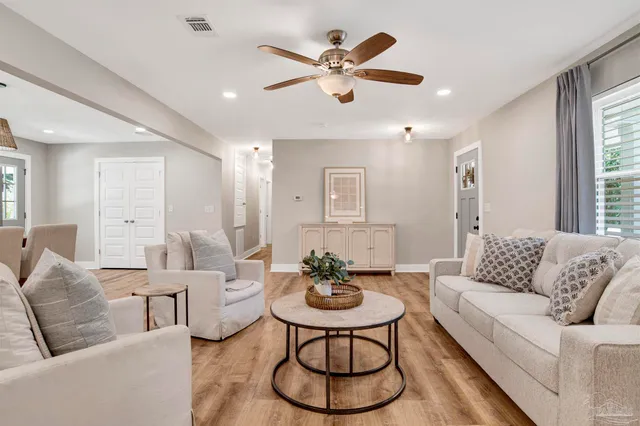 a living room with furniture and white walls