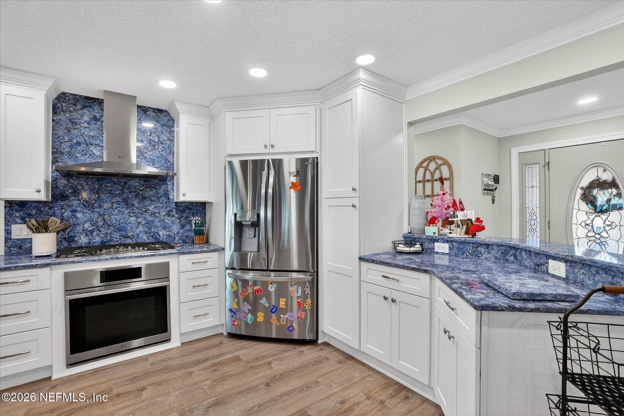 6447 Jack Wright Island Road St. Augustine, FL 32092 - Photo 11 of 37 a kitchen with stainless steel appliances granite countertop a stove refrigerator and cabinets