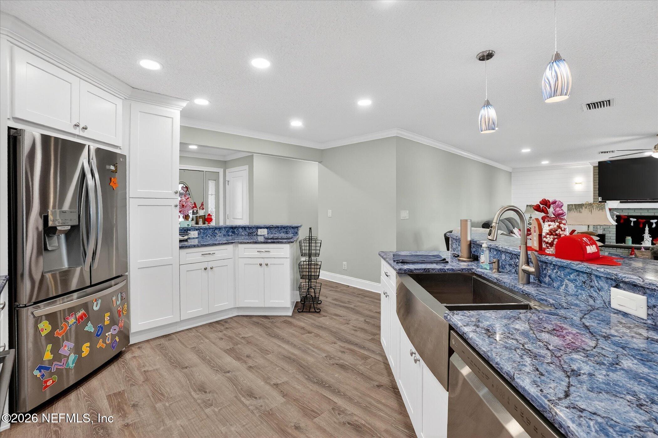 6447 Jack Wright Island Road St. Augustine, FL 32092 - Photo 13 of 37 a kitchen with stainless steel appliances granite countertop a sink stove and refrigerator
