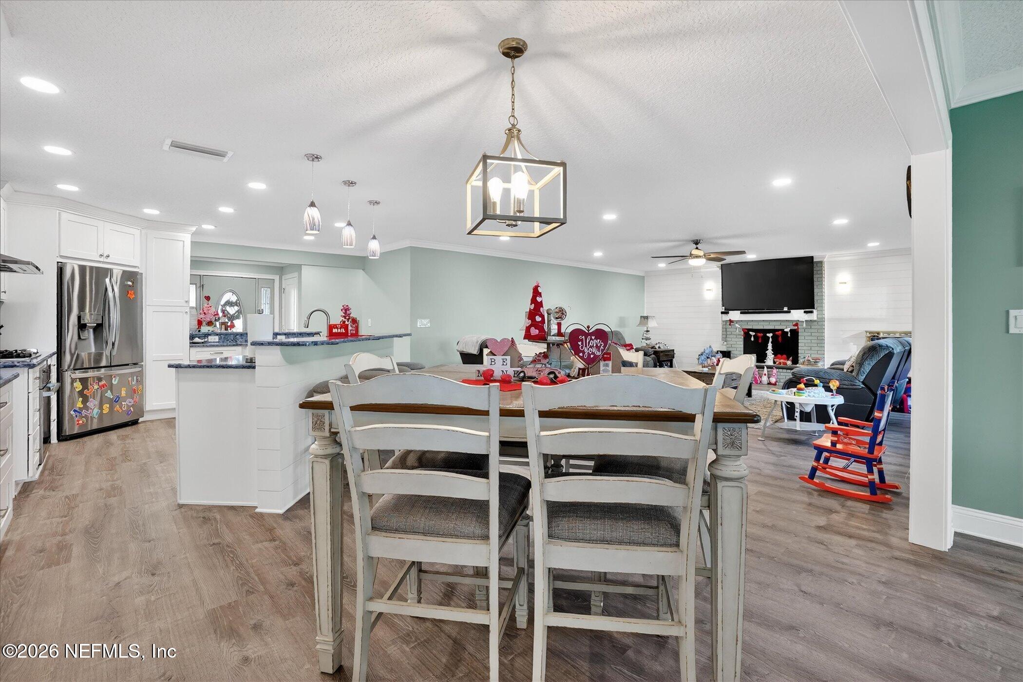 6447 Jack Wright Island Road St. Augustine, FL 32092 - Photo 14 of 37 a view of a dining room with furniture and wooden floor