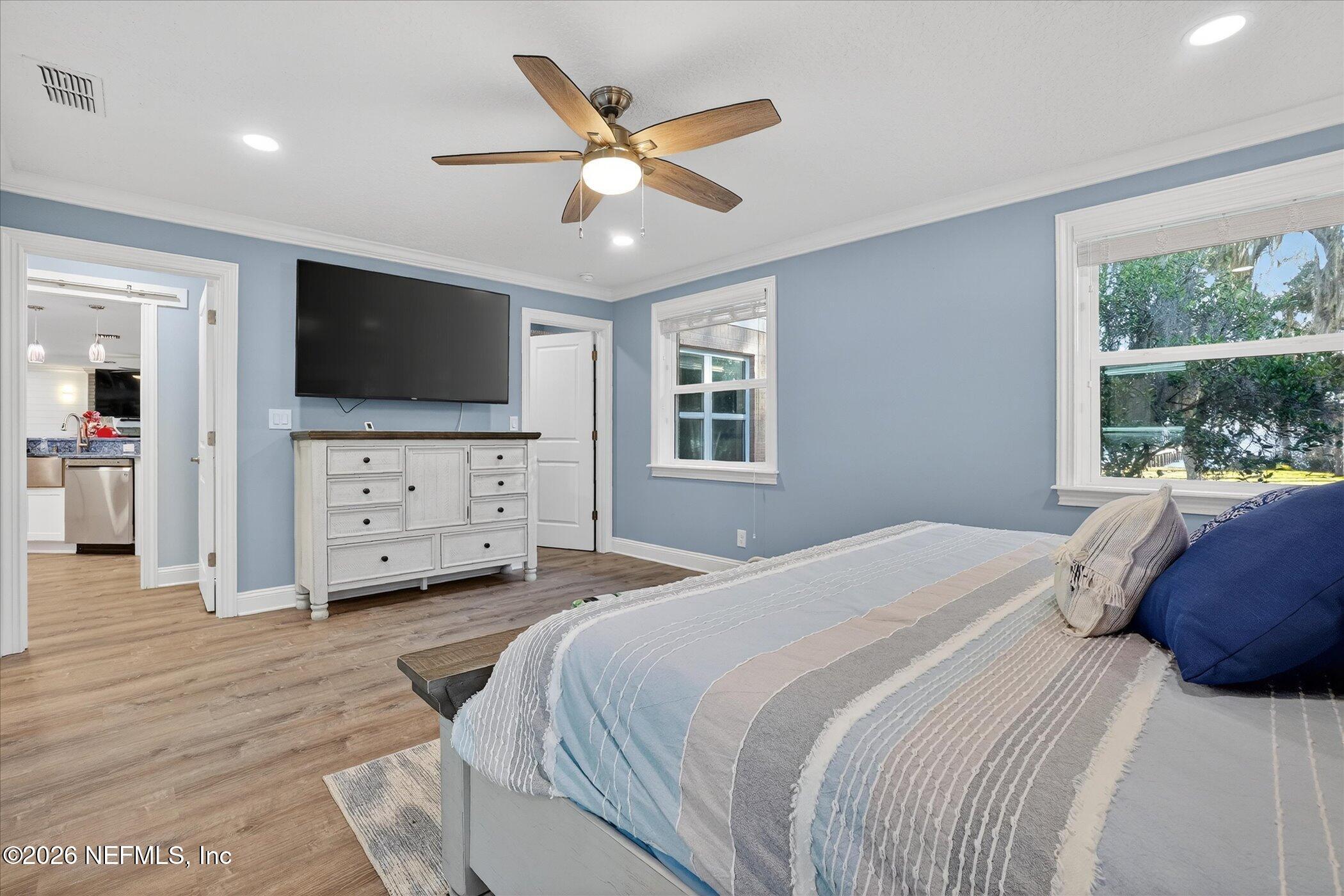 6447 Jack Wright Island Road St. Augustine, FL 32092 - Photo 19 of 37 a bedroom with a large bed and a flat screen tv