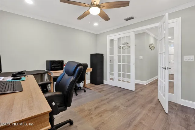 a view of a workspace with furniture and a window