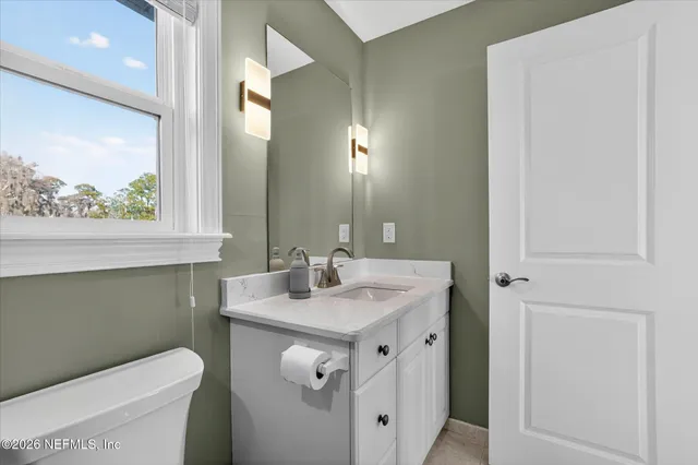 a bathroom with a sink toilet and a mirror