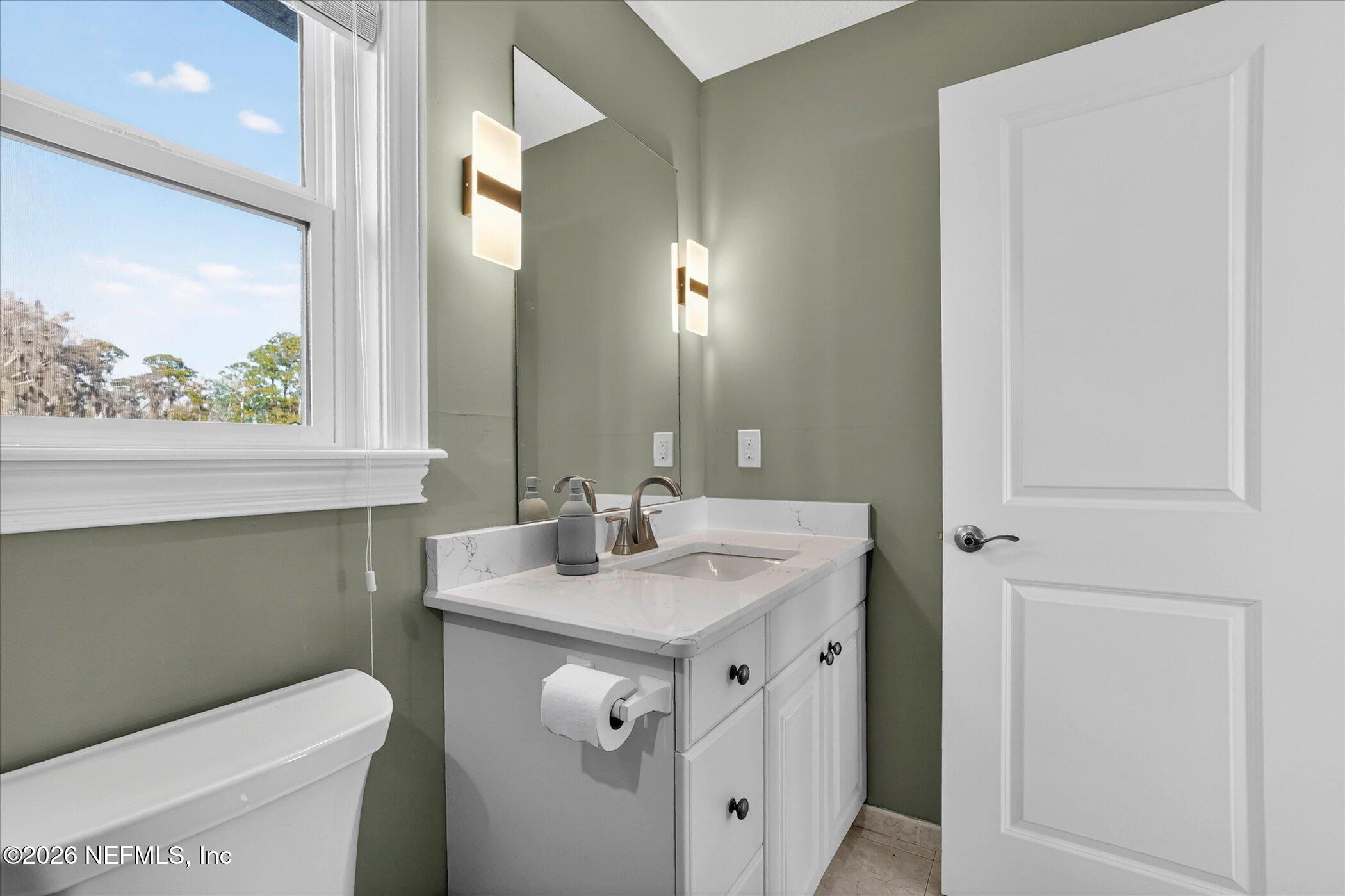 6447 Jack Wright Island Road St. Augustine, FL 32092 - Photo 26 of 37 a bathroom with a sink toilet and a mirror