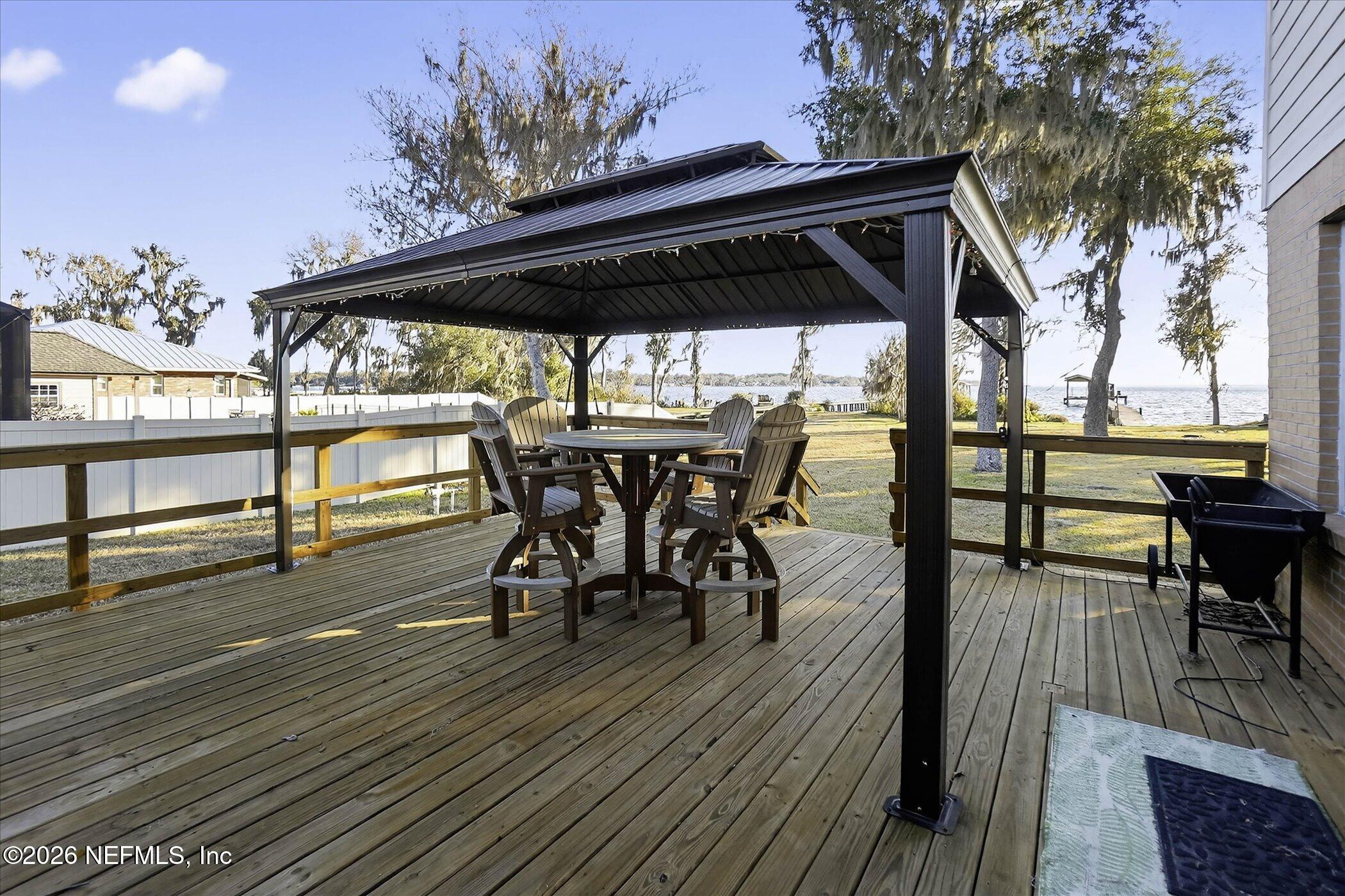 6447 Jack Wright Island Road St. Augustine, FL 32092 - Photo 27 of 37 a view of outdoor dining space with a table and chairs