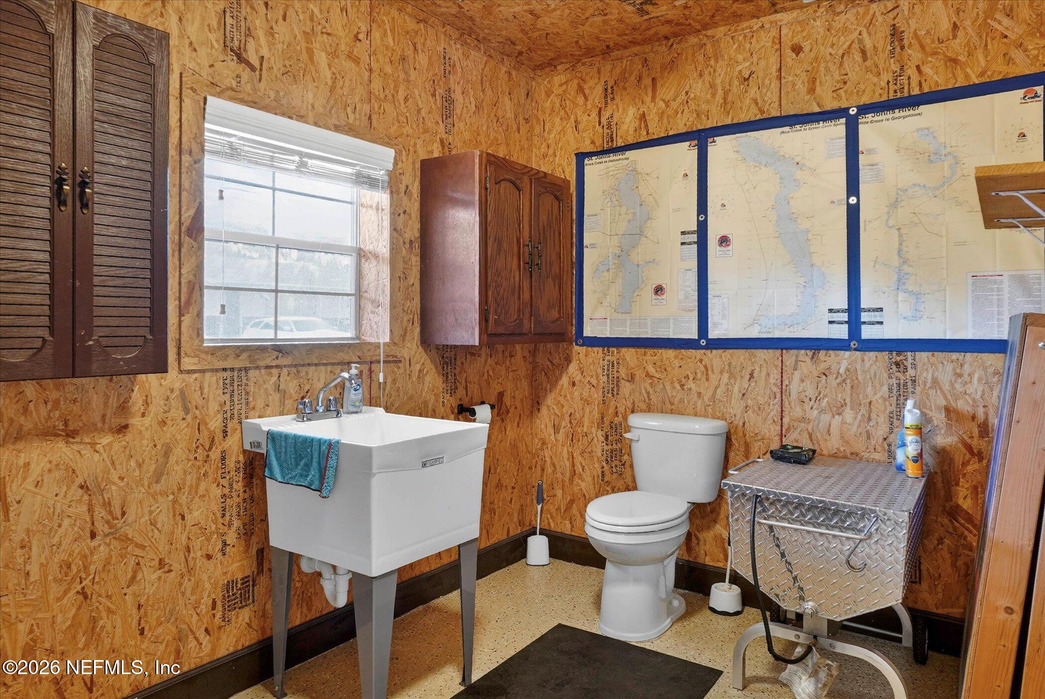 6447 Jack Wright Island Road St. Augustine, FL 32092 - Photo 37 of 37 a bathroom with a toilet sink and mirror