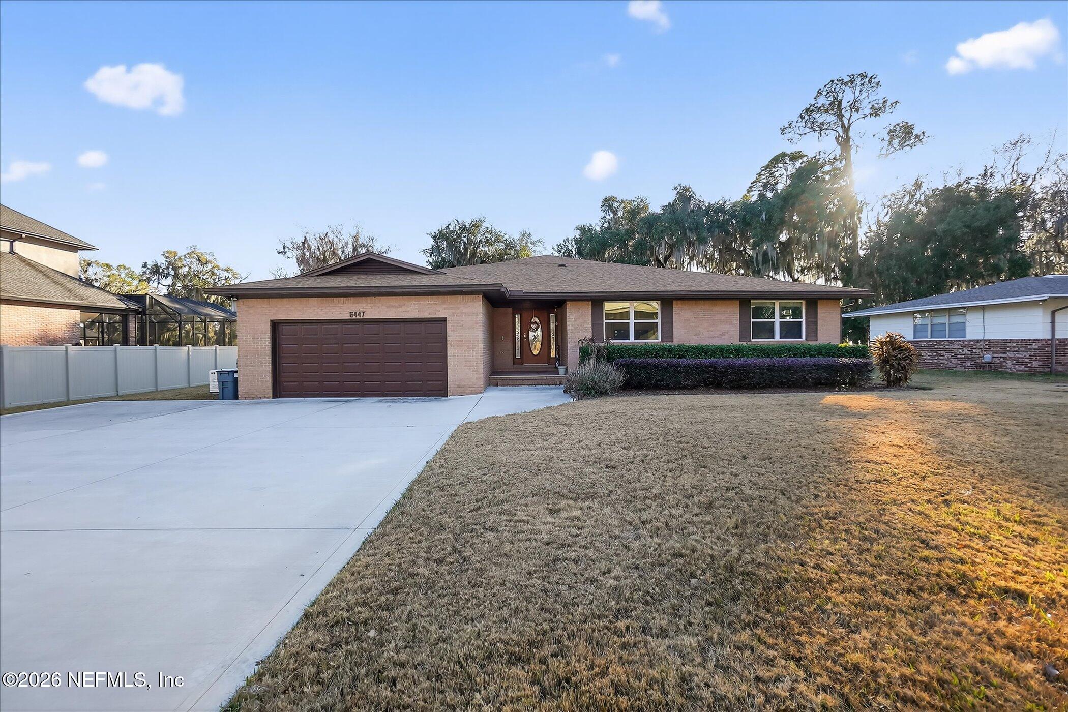 6447 Jack Wright Island Road St. Augustine, FL 32092 - Photo 6 of 37 a front view of a house with a yard and potted plants