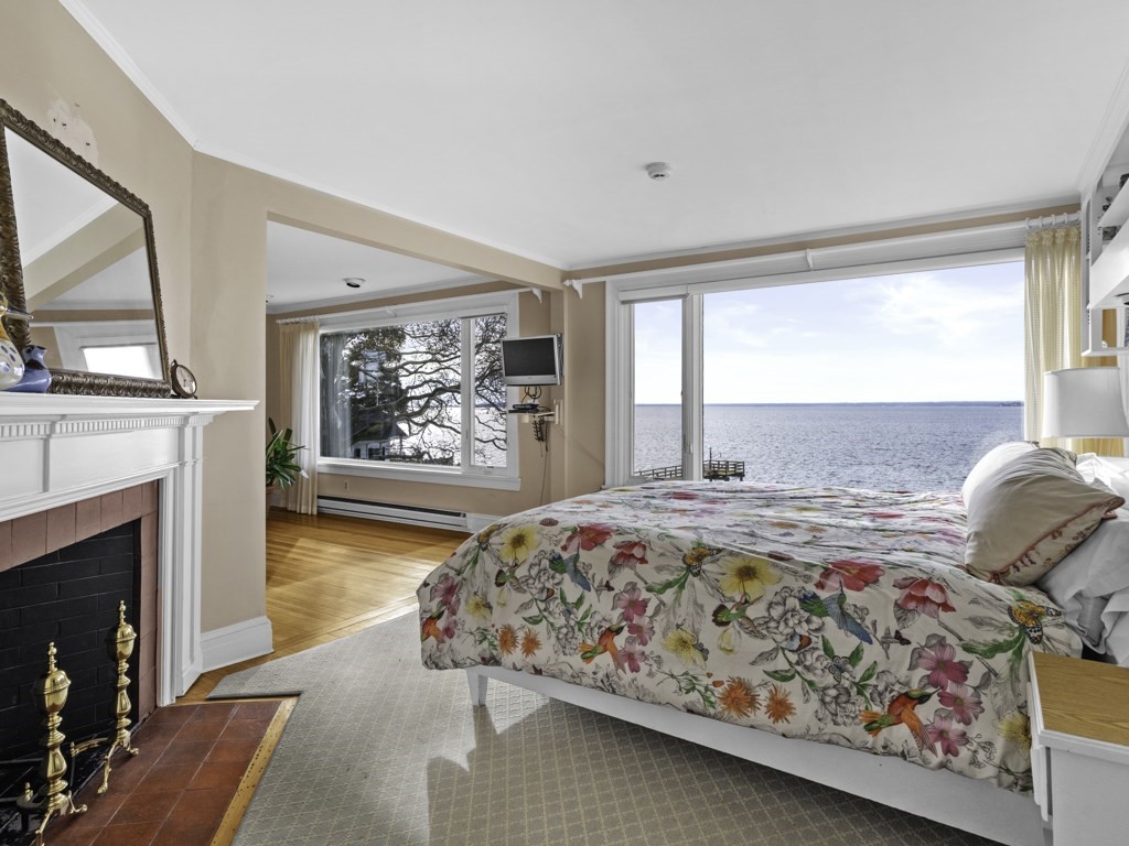 247 King Caesar Road Duxbury, MA 02332 - Photo 22 of 38 a bedroom with a bed and a fireplace
