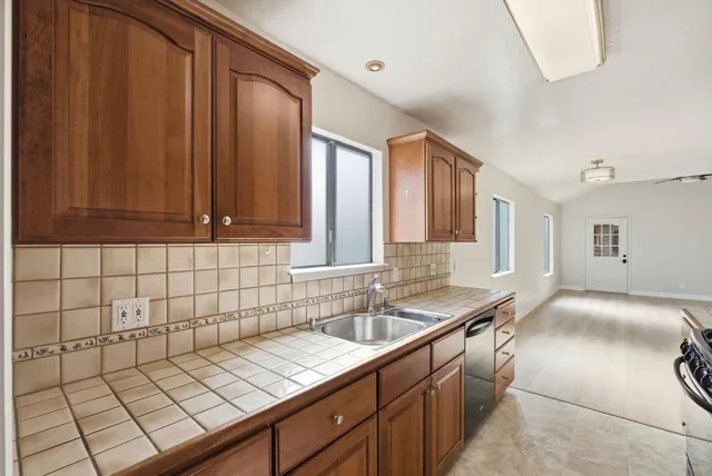 a kitchen with stainless steel appliances granite countertop a stove microwave and refrigerator