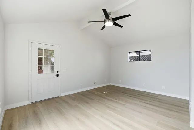 wooden floor in an empty room with a window