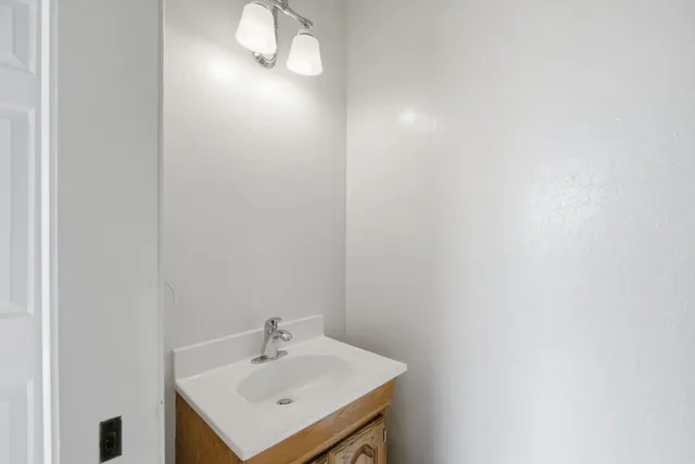 a view of a house with a small yard and wooden fence