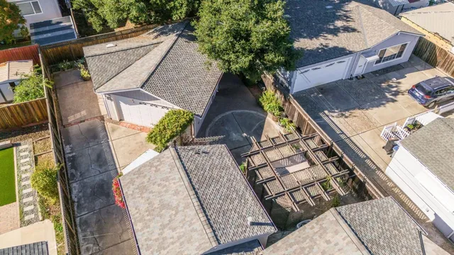 an aerial view of a house with a yard and trees