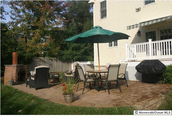 1233 Crosby Road Spring Lake Heights, NJ 07762 - Photo 2 of 3 a view of a patio with a table and chairs under an umbrella