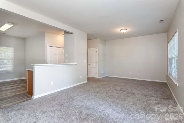 an empty room with windows and closet
