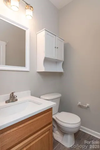 a bathroom with a sink a toilet and mirror