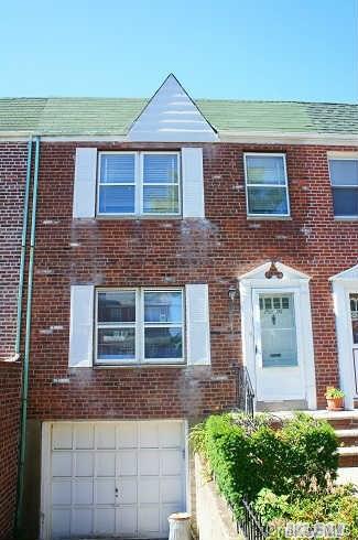 150-24 61st Road Queens, NY 11367 - Photo 1 of 1 a front view of a house with a yard