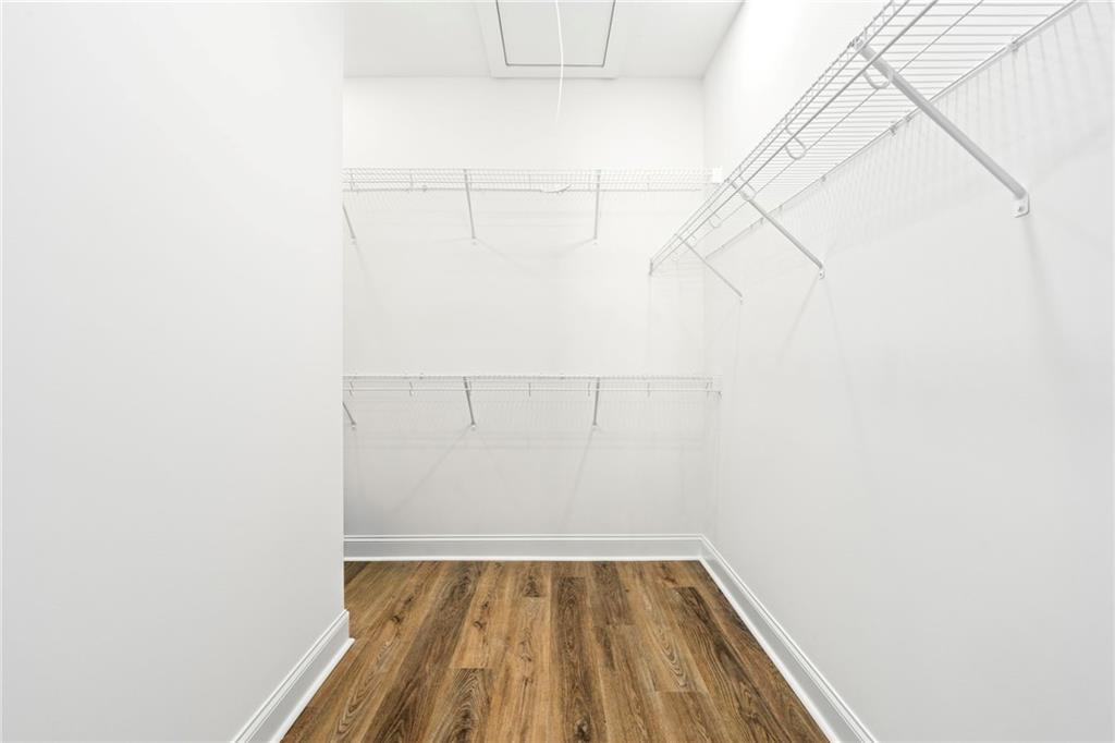 3216 South Phillips Road Lanett, AL 36863 - Photo 14 of 23 Walk-in closet featuring wire shelving, wire hanging rods, wood-finish flooring, and white walls