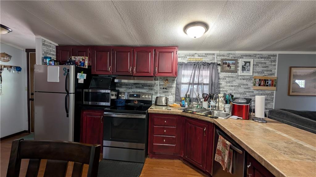 203 Colvin Road Greensboro, PA 15338 - Photo 3 of 20 a kitchen with stainless steel appliances granite countertop a refrigerator and a stove top oven