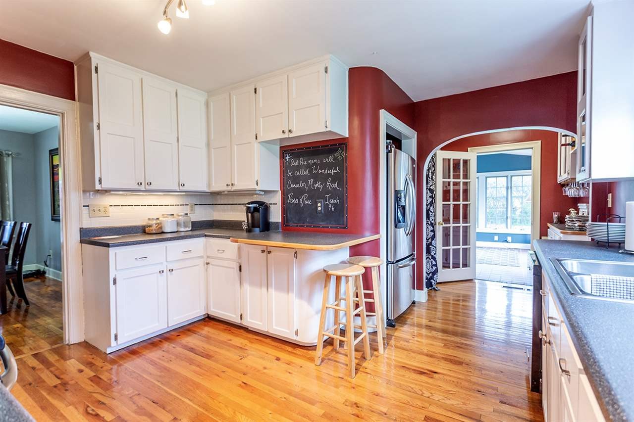 304 Georgetown Road Northwest Cleveland, TN 37311 - Photo 21 of 45 a open kitchen with stainless steel appliances granite countertop a stove top oven a sink dishwasher and white cabinets with wooden floor