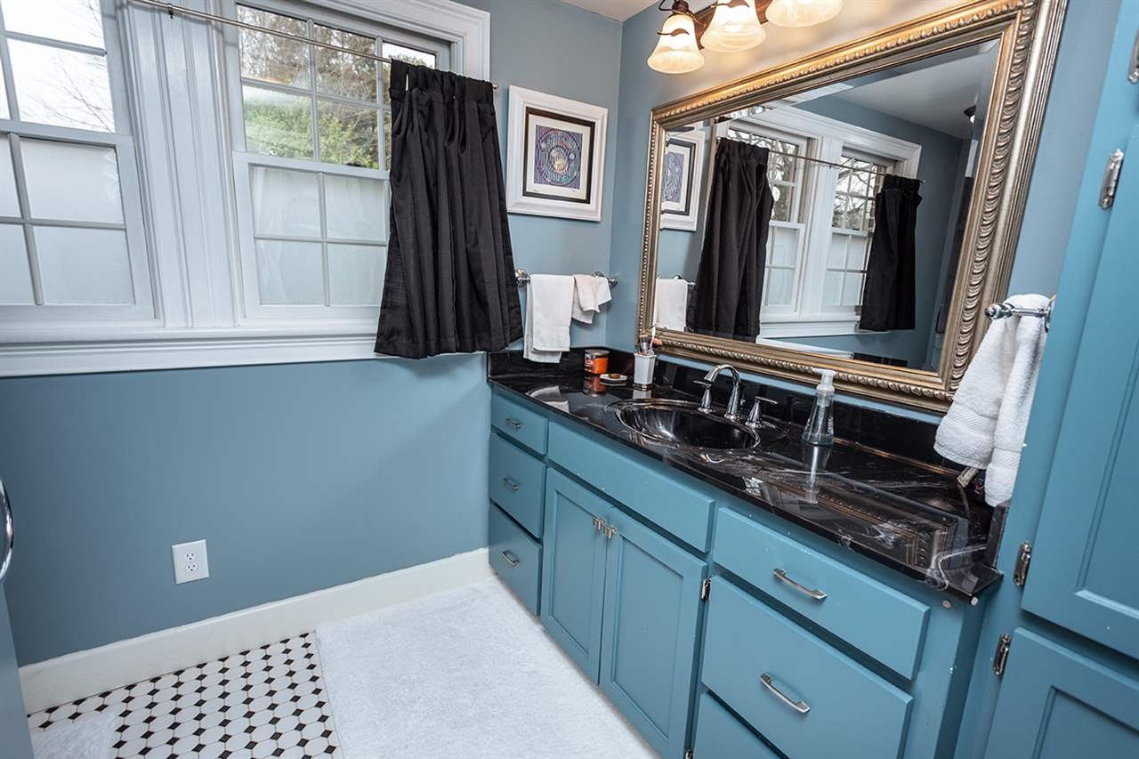 304 Georgetown Road Northwest Cleveland, TN 37311 - Photo 28 of 45 a bathroom with a sink a mirror and window