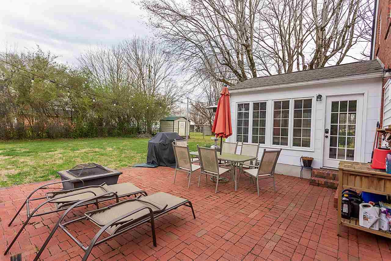 304 Georgetown Road Northwest Cleveland, TN 37311 - Photo 6 of 45 a view of a patio with lawn chairs floor to ceiling window and pool table and chairs