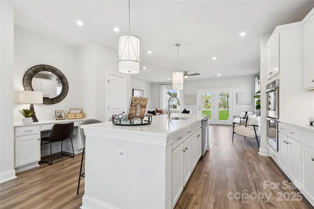 a kitchen with a sink appliances and cabinets