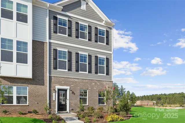 a front view of a building with a garden